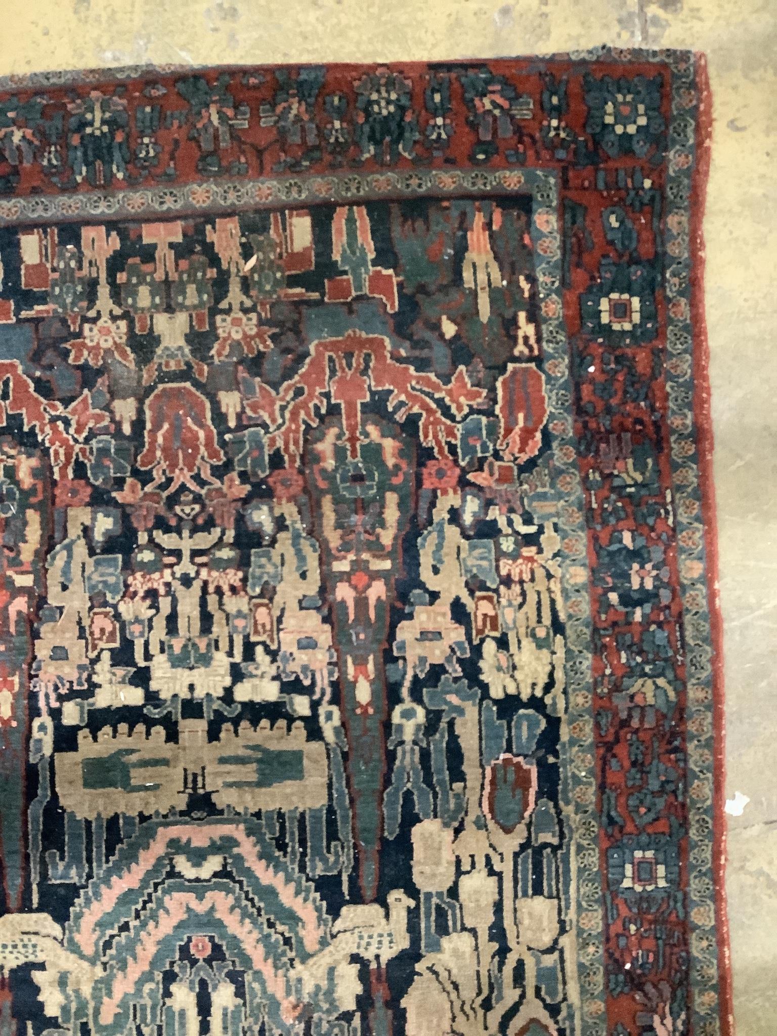 An antique Persian blue ground rug, woven with birds within a garden, 170 x 120cm